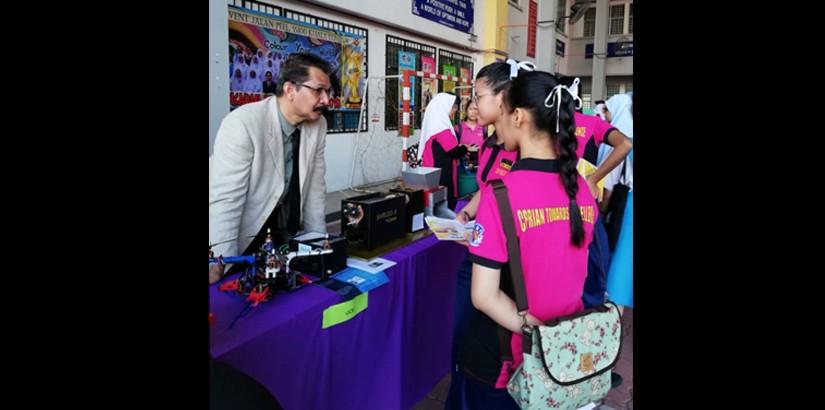 Students visiting the booths to see the engineering projects.