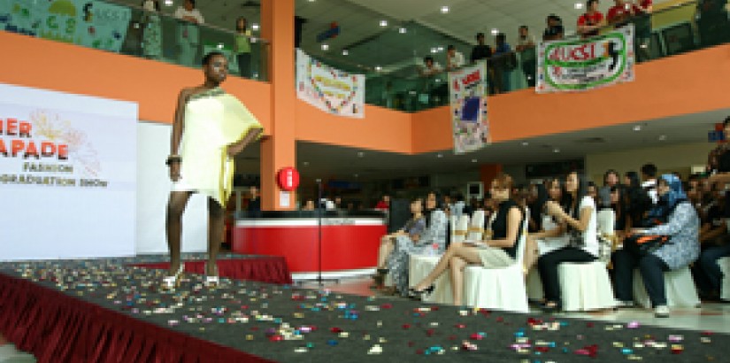 A graduate modeling one of the sponsor’s designs