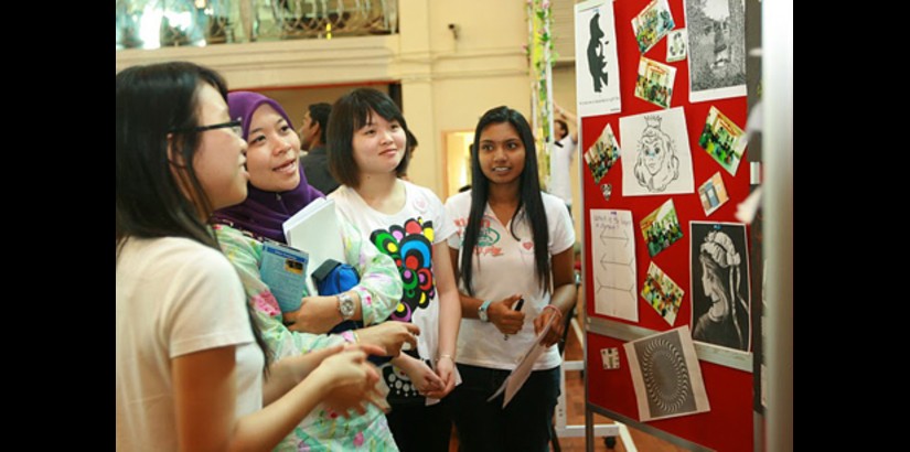 UCSI University first year students explaining their project to one of the judges during the 'University Life' final showcase