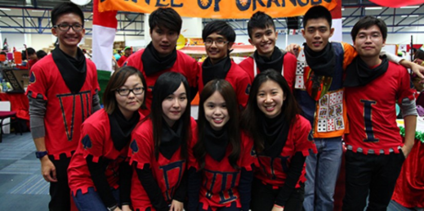 ORANGE UPRISING: Foo Chee Wei (Standing, far left) and his team in front of their Battle of Orange booth that celebrates the downfall of a 13th century north Italian tyrant.