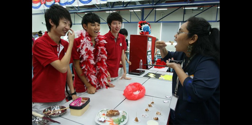  Ms Adeline Cruz tasting one of the dishes prepared by the students in showcasing the country they chose
