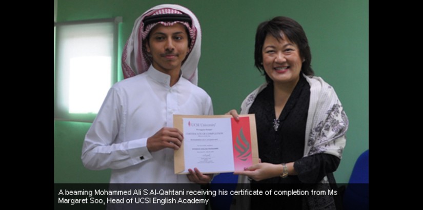 A beaming Mohammad Ali S Al-Qahtani receiving his certificate of completion from Ms Margaret Soo, Head of UCSI English Academy