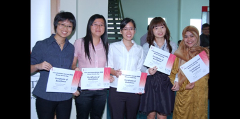 Jubilant students showing off their certificates of excellence