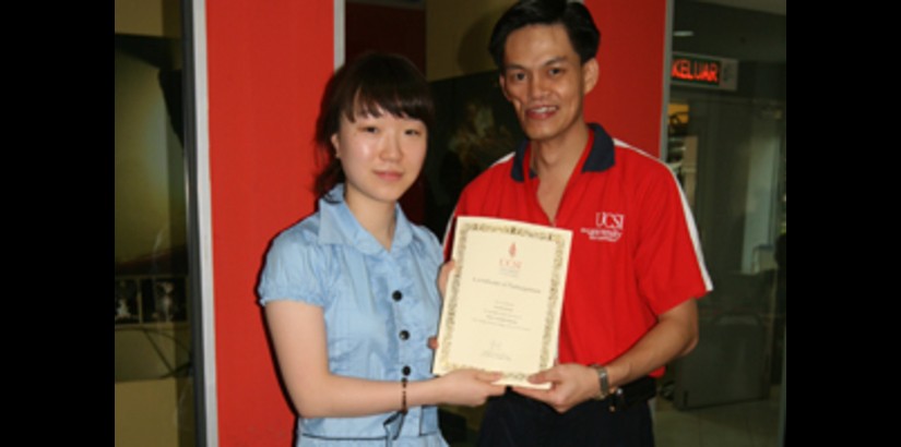 UCSI University’s Manager of International Office, Mr. Roland Chan presenting a certificate of participation to a South Korean student