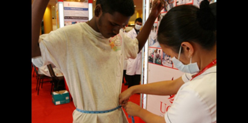One of the nursing students measuring a member of the public as part of the Body Mass Index test