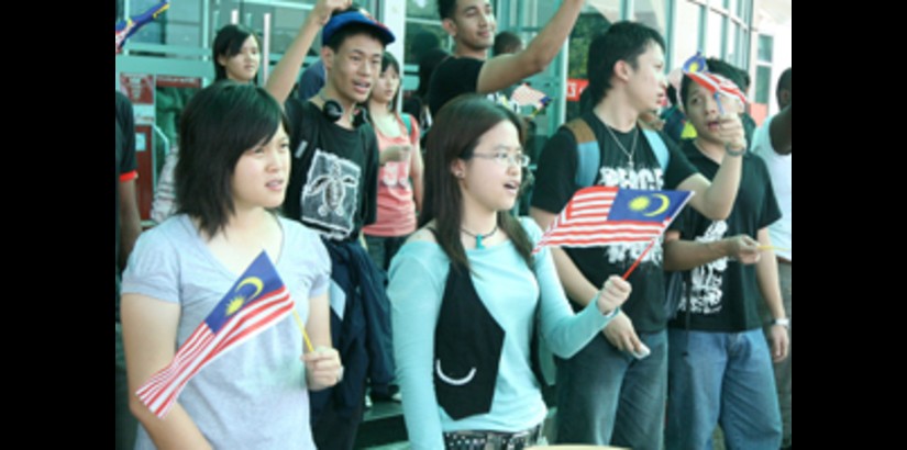 Students Waving the Malaysian Flag and Singing the National Anthem