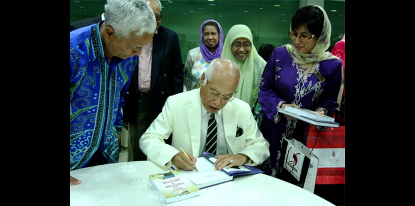 Tan Sri Datuk Seri Panglima Dr. Abdul Rahman Arshad autographs his books for guests
