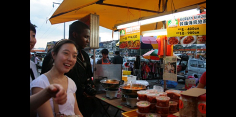 UCSI University student, Henry Angala, accompanying one of the SMU students during a trip to the night market in Cheras