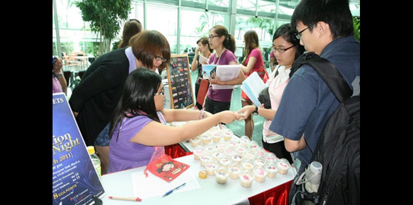  Students sell feminine-themed cupcakes during the International Women's Week festivities at UCSI University.