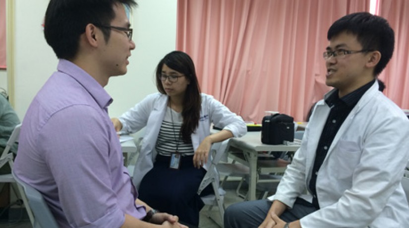 Tung Him Soon (left) roleplaying a physical examination with local medical students.