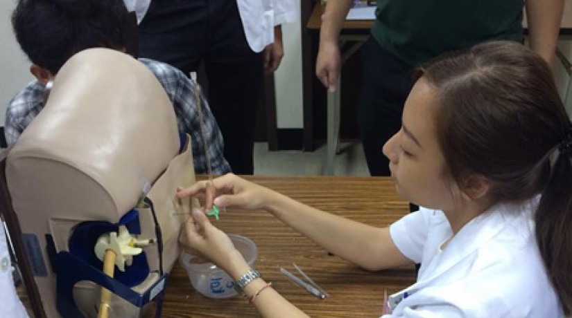 Low Zhen Ning practices the lumbar puncture procedure on a mannequin.