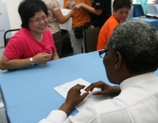 Dr. Ogunbanjo counsels one of the residents who participated in the health screening tests at the community centre.