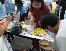 TEAMWORK: Participants painting one of several mysterious canvases that were later fitted together to reveal a beautiful mural to commemorate World Autism Awareness Day 2016.