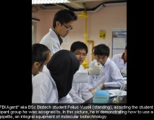 The "FBI Agent" aka BSc Biotech student Felius Yuseli (standing), assisting the student participant group he was assigned to. He is demonstrating how to use a micropipette, an integral equipment of molecular biotechnology.