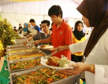 Guests enjoying tables of food and Ramadan treats during the celebration.