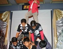 Children from the home building a human pyramid at the end of their performance