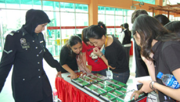 A police officer from Ibu Pejabat Daerah Cheras explains about the drugs on exhibition at UCSI University recently