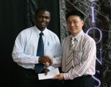 Angala Henry Tonye receiving his letter of appointment from the Vice President of Business Development and Student Affairs, Mr. Moses Ling