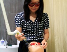  HANDS-ON EXPERIENCE: Dr Ho Choon Moy in the midst of conducting a facial treatment on a volunteer.