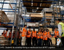 ALL EARS: Student at a briefing during a warehouse tour at PKT Logistics