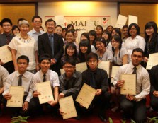 A jubilant group of scholarship awardees posing with the guests of honor.