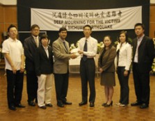 Cheque Handover: Assoc. Prof. Dr. Lachman handing over the cheque to Mr Gu from the embassy, flanked by UCSI student and management representatives.