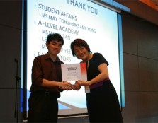 Ms. Margaret Soo, Vice President of Group Corporate Affairs presenting a certificate of appreciation to an A-levels student for his participation as a Will Group facilitator