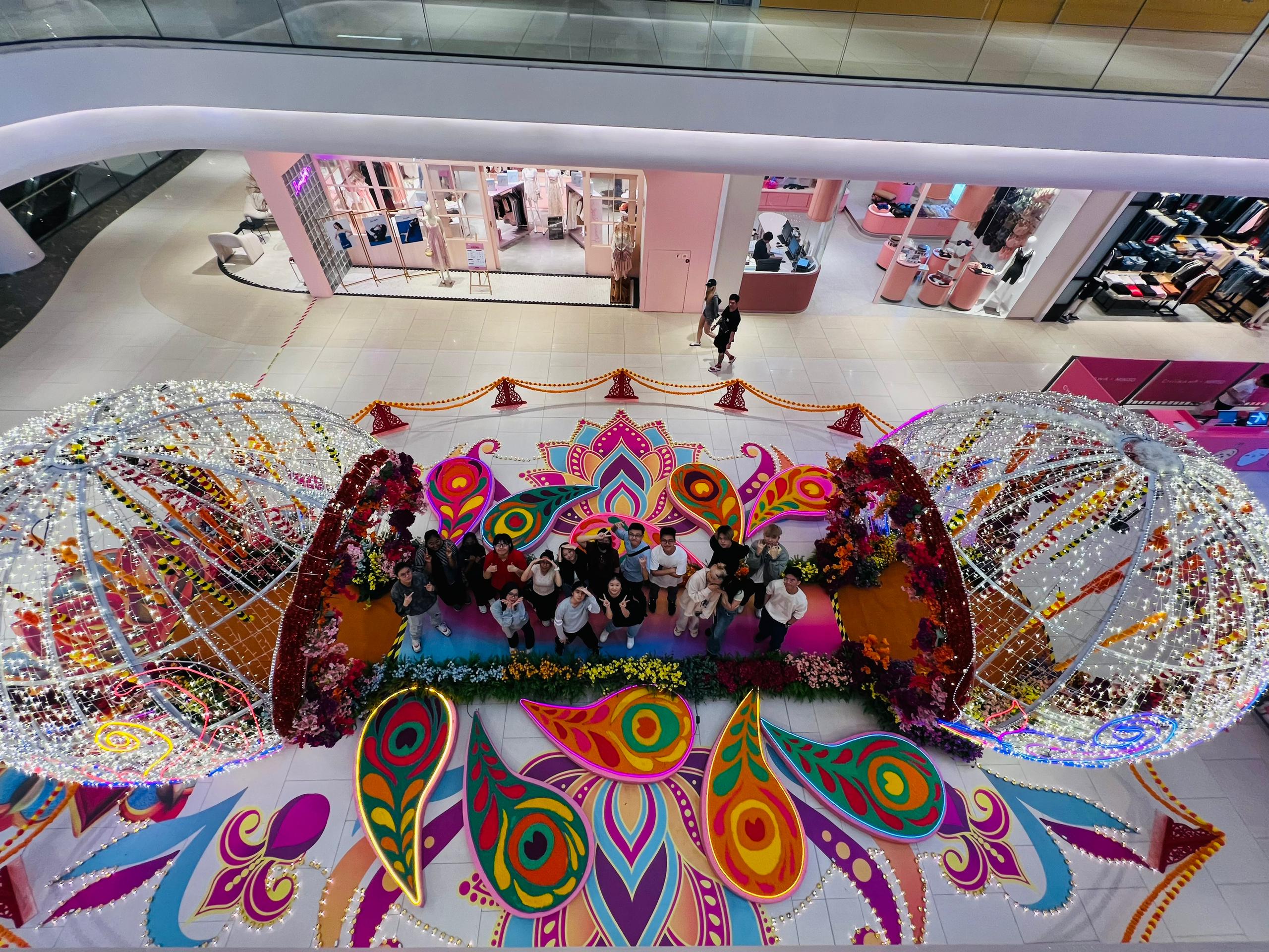 Some UCSI students who participated in the kolam creation pose for a photo with the large kolam after the unveiling ceremony.